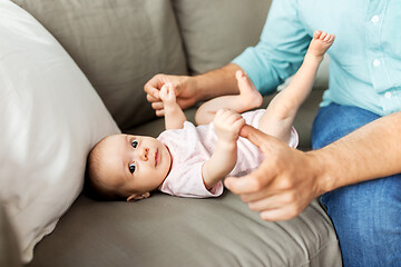 Image showing middle aged father playing with baby at home