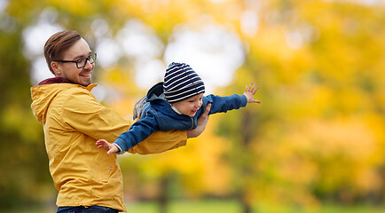 Image showing father with son playing and having fun in autumn