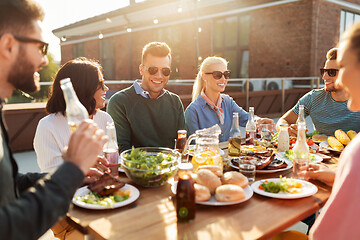 Image showing friends having dinner or bbq party on rooftop