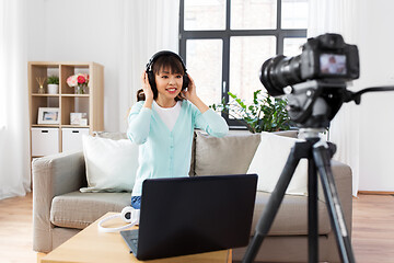 Image showing female blogger with headphones making video blog