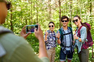 Image showing friends with backpacks being photographed on hike