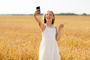 Image showing girl taking selfie by smartphone and showing peace