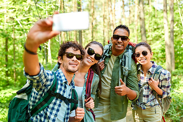 Image showing friends with backpacks hiking and taking selfie