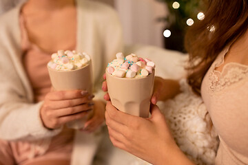 Image showing two women drinking hot chocolate with marshmallow