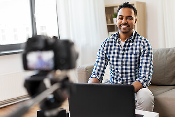 Image showing male blogger with camera videoblogging at home