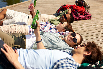 Image showing friends drinking beer and cider on lake pier