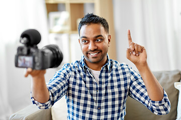 Image showing male video blogger with camera blogging at home