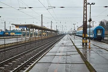 Image showing Railway station with passaenger trains in rain