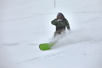 Image showing Snowboarding in fresh powder snow