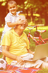 Image showing grandfather and child using laptop