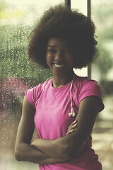 Image showing portrait of young afro american woman in gym while listening mus