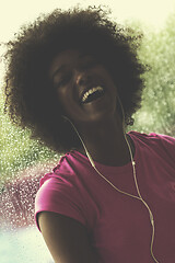 Image showing portrait of young afro american woman in gym while listening mus