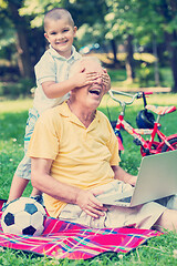 Image showing grandfather and child using laptop