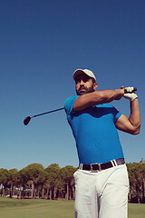 Image showing golf player hitting shot