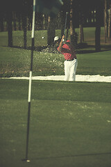 Image showing golfer hitting a sand bunker shot