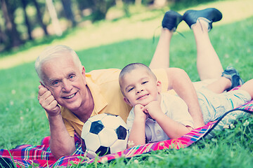 Image showing grandfather and child have fun  in park