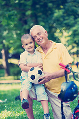 Image showing grandfather and child have fun  in park