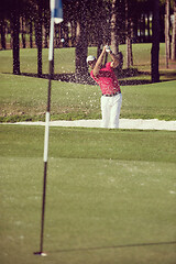 Image showing golfer hitting a sand bunker shot