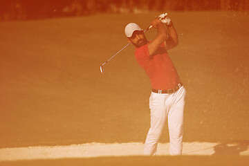 Image showing golfer hitting a sand bunker shot