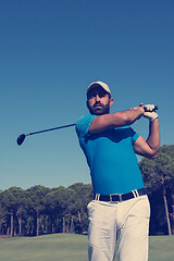 Image showing golf player hitting shot