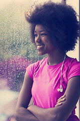 Image showing portrait of young afro american woman in gym while listening mus