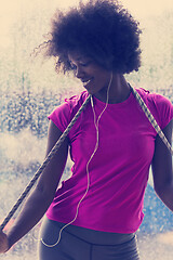 Image showing portrait of young afro american woman in gym while listening mus