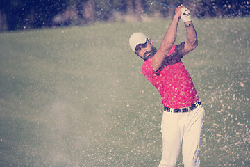 Image showing golfer hitting a sand bunker shot