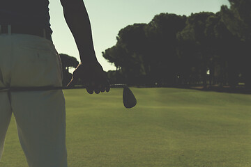 Image showing golf player close up hand and driver from back