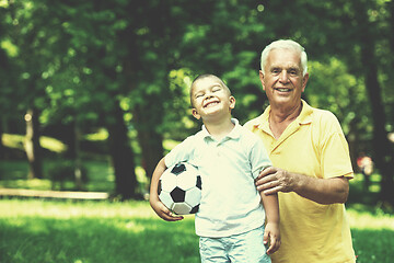 Image showing grandfather and child have fun  in park