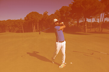 Image showing golf player hitting shot