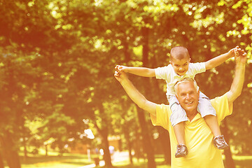 Image showing grandfather and child have fun  in park