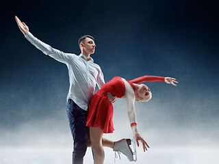 Image showing Professional man and woman figure skaters performing on ice show