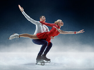 Image showing Professional man and woman figure skaters performing on ice show