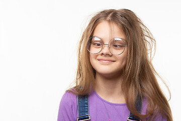 Image showing Girl with glasses trying to look at her nose.