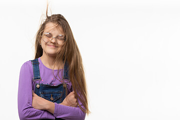 Image showing A girl of eleven from the wind tangled in long hair