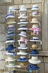 Image showing A lot of various women's hats in the street shop