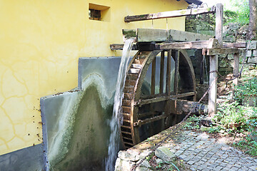 Image showing Old wooden wheel from a mill on the river