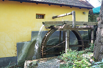 Image showing Old wooden wheel from a mill on the river