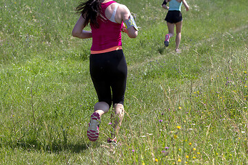 Image showing Young women running in nature on a rural road 