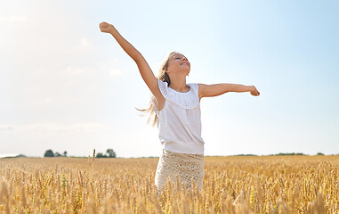 Image showing happy smiling young girl on cereal field in summer