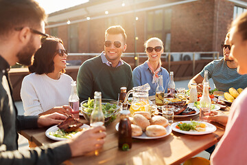 Image showing friends having dinner or bbq party on rooftop