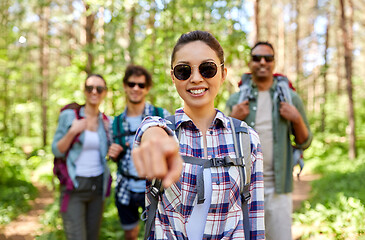 Image showing friends with backpacks on hike in forest