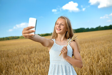 Image showing happy young girl taking selfie by smartphone