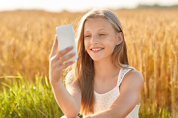 Image showing happy young girl taking selfie by smartphone