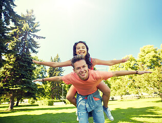 Image showing happy teenage couple having fun at summer park