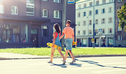 Image showing teenage couple with skateboards on city crosswalk