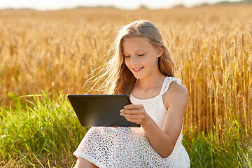 Image showing smiling with tablet computer on cereal field