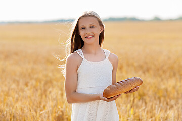 Image showing girl with loaf of white bread on cereal field