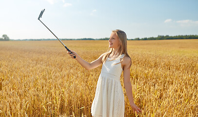 Image showing happy young girl taking selfie by smartphone