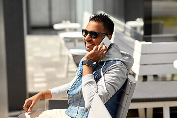 Image showing indian man calling on smartphone at street cafe